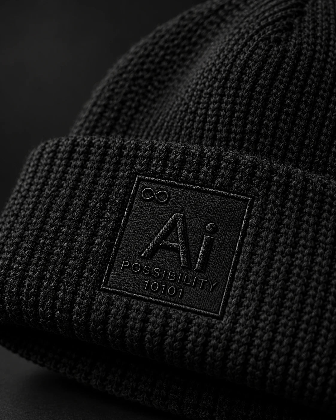 Close-up of the tone-on-tone embroidered Ai + You element tile on the ribbed cuff of the Possibility Beanie