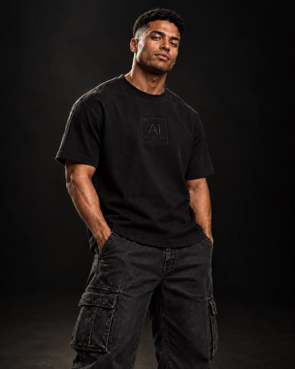 Model wearing the Possibility Box Tee in black with cargo pants, dark studio