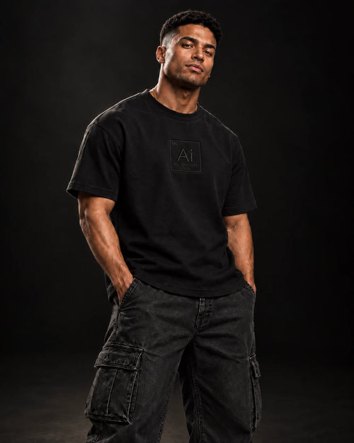 Model wearing the Possibility Box Tee in black with cargo pants, dark studio