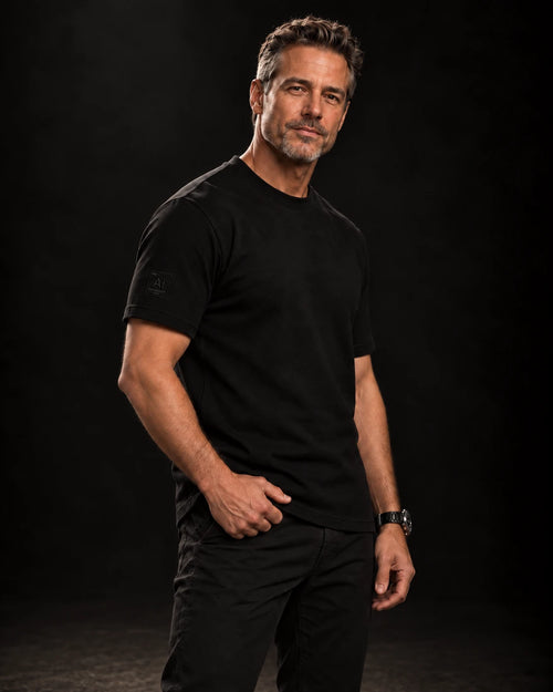 Model wearing the Possibility Fitted Tee in black with the Ai element tile on the right sleeve, dark studio