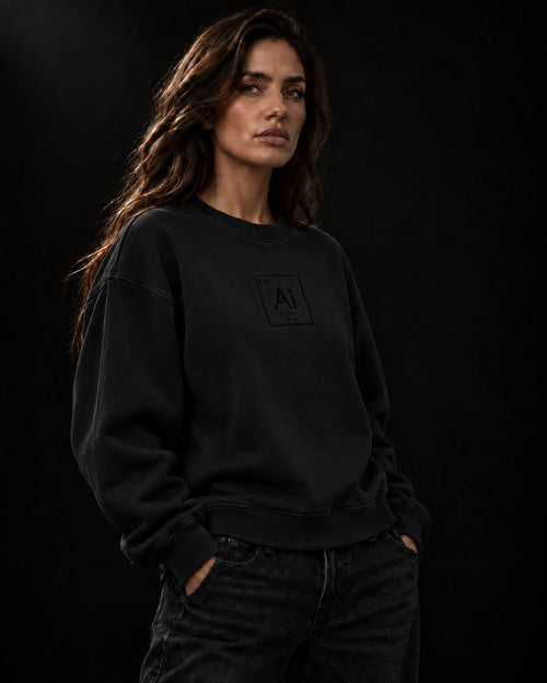 Model wearing the Ai + You Possibility Crewneck in washed black against a dark studio backdrop