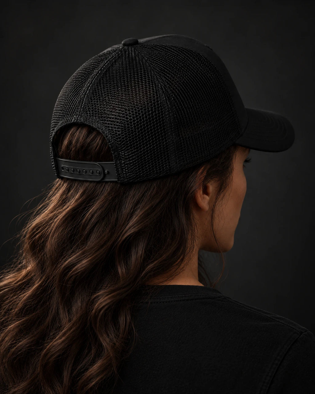 Back view of the Possibility Trucker Hat showing the black mesh and adjustable snap closure